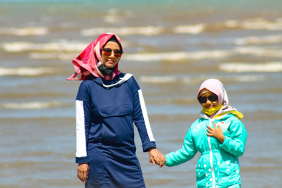 Portrait of women standing at sea shore