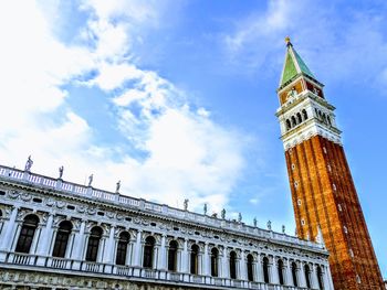 Low angle view of clock tower against sky in city