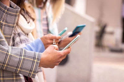 Midsection of woman using mobile phone