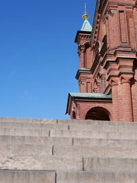 Low angle view of historic building against clear blue sky