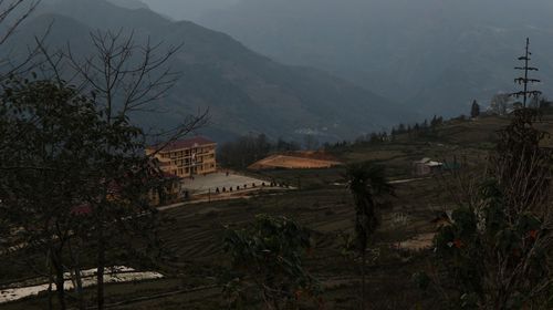 High angle view of buildings and trees against sky