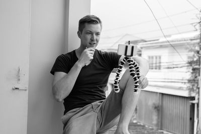 Smiling man talking on video call at balcony