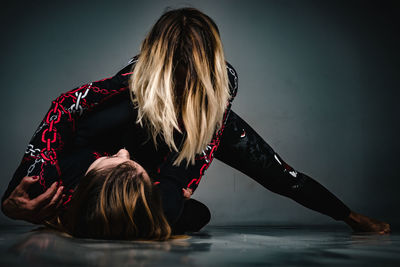 Rear view of woman with hands in water