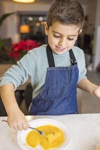 Mother and son making croquettes in the kitchen