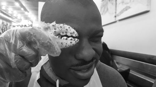 Close-up portrait of man holding king crab