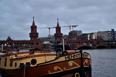 View of bridge over river against cloudy sky