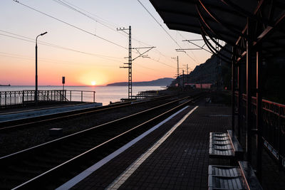 Railroad tracks against sky during sunset