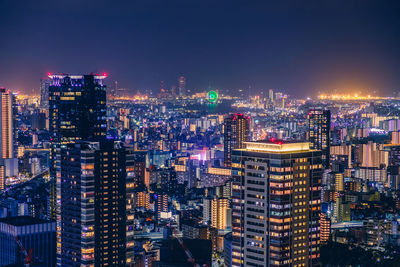 High angle view of illuminated osaka city buildings against sky