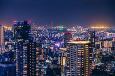 High angle view of illuminated city buildings against sky