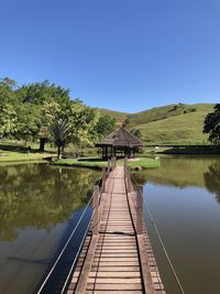 Low angle view of bridge against clear blue sky