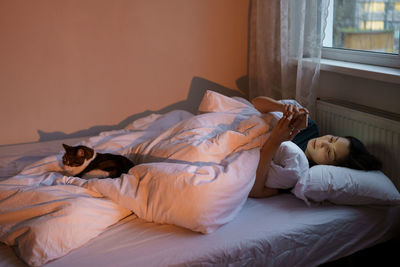 High angle view of woman sleeping on bed at home