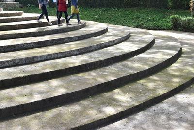 Low section of people standing on zebra crossing