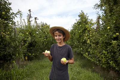 Portrait of a boy in an apple field