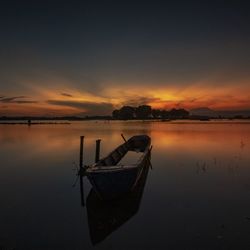 Boat in lake during sunset