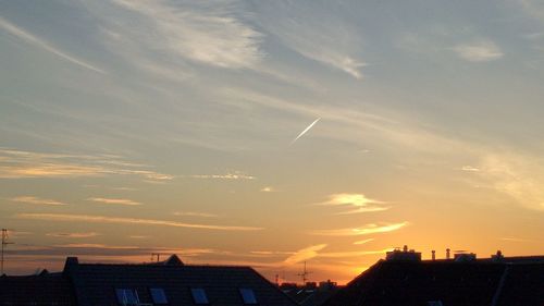 Vapor trail in sky during sunset