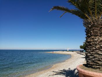 Scenic view of sea against clear blue sky