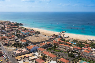 High angle view of buildings and sea against sky