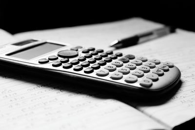 Close-up of calculator and book on table