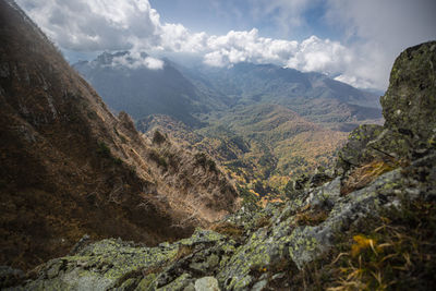 Scenic view of valley and mountains against sky