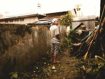 Rear view of people working on building