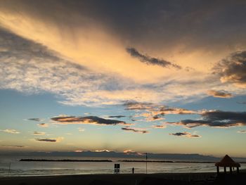 Scenic view of beach against sky during sunset