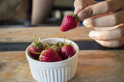 Close-up of hand holding strawberries