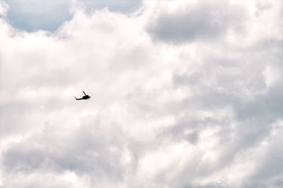Low angle view of silhouette airplane against sky