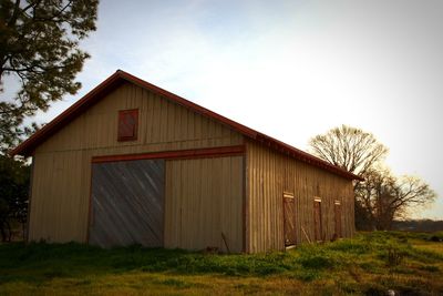 Barn in house against sky