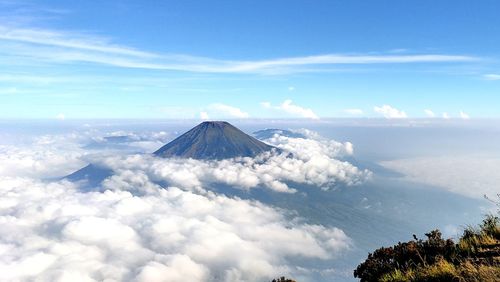 Aerial view of snowcapped mountain against cloudy sky