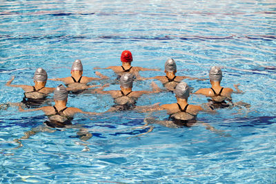 Rear view of women swimming in pool