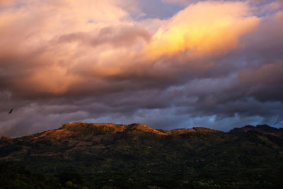 Low angle view of storm clouds over mountains