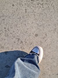 Low section of person standing on footpath