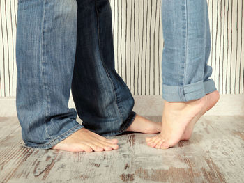 Low section of man with woman standing on floor