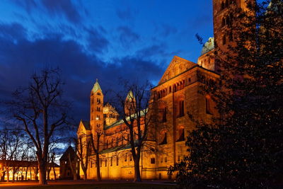 Illuminated buildings against sky at dusk