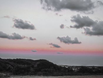 Scenic view of landscape against dramatic sky