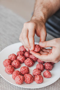 Close-up of hand holding strawberries