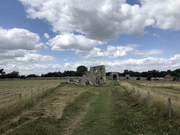 Old ruins on field against sky