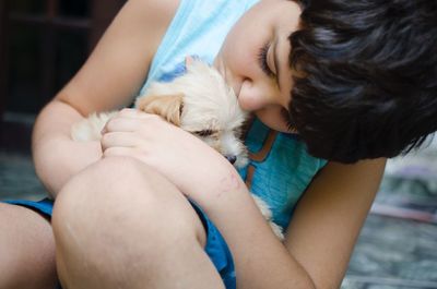 Close-up of cute boy holding puppy
