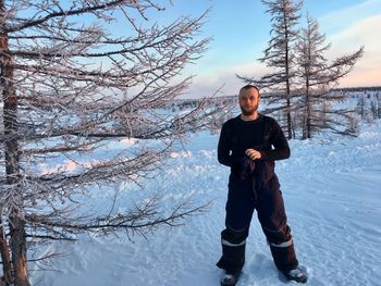 Full length of man standing on snow covered land