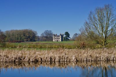 Scenic view of lake against clear blue sky