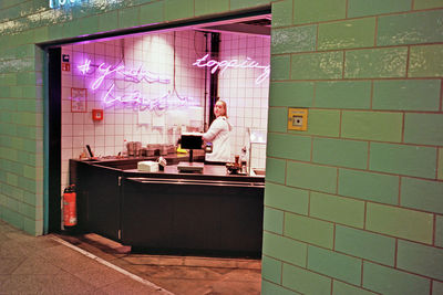 Portrait of woman standing at cake shop