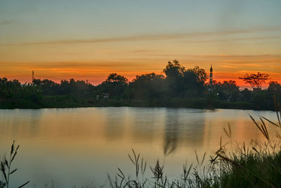 Scenic view of lake against orange sky