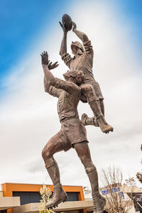 Low angle view of statue against sky