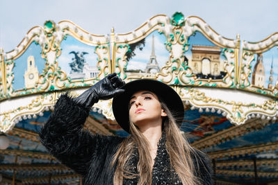 Portrait of beautiful young woman wearing hat