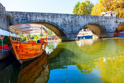 Arch bridge over river against sky