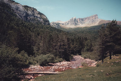 Panoramic view of land and mountains against sky