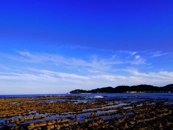 Scenic view of sea against blue sky