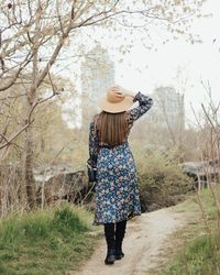 Rear view of woman standing on field