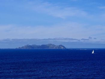 Scenic view of sea against blue sky