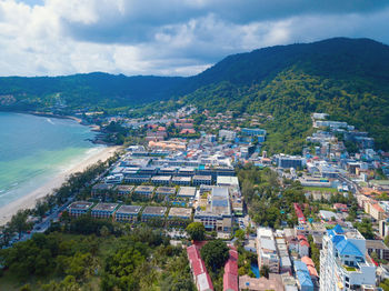 High angle view of townscape by sea against sky